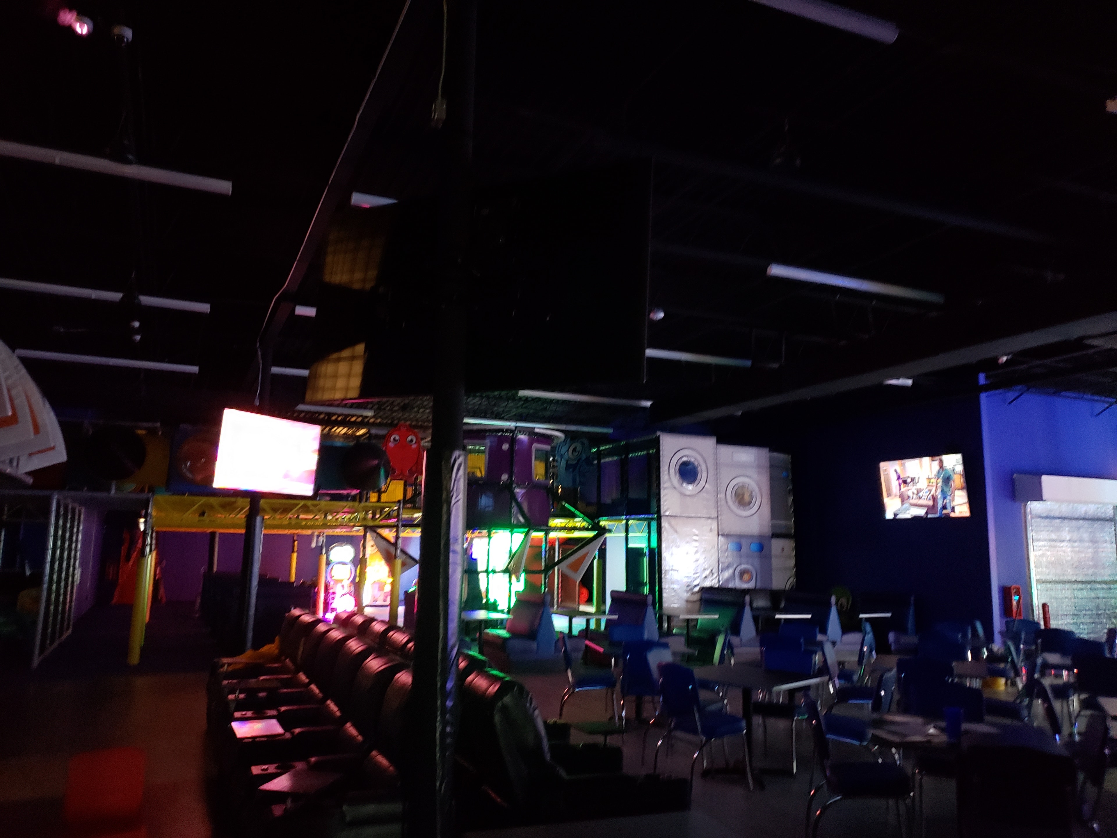 Arcade game room with neon lights — entertainment venue pre-install