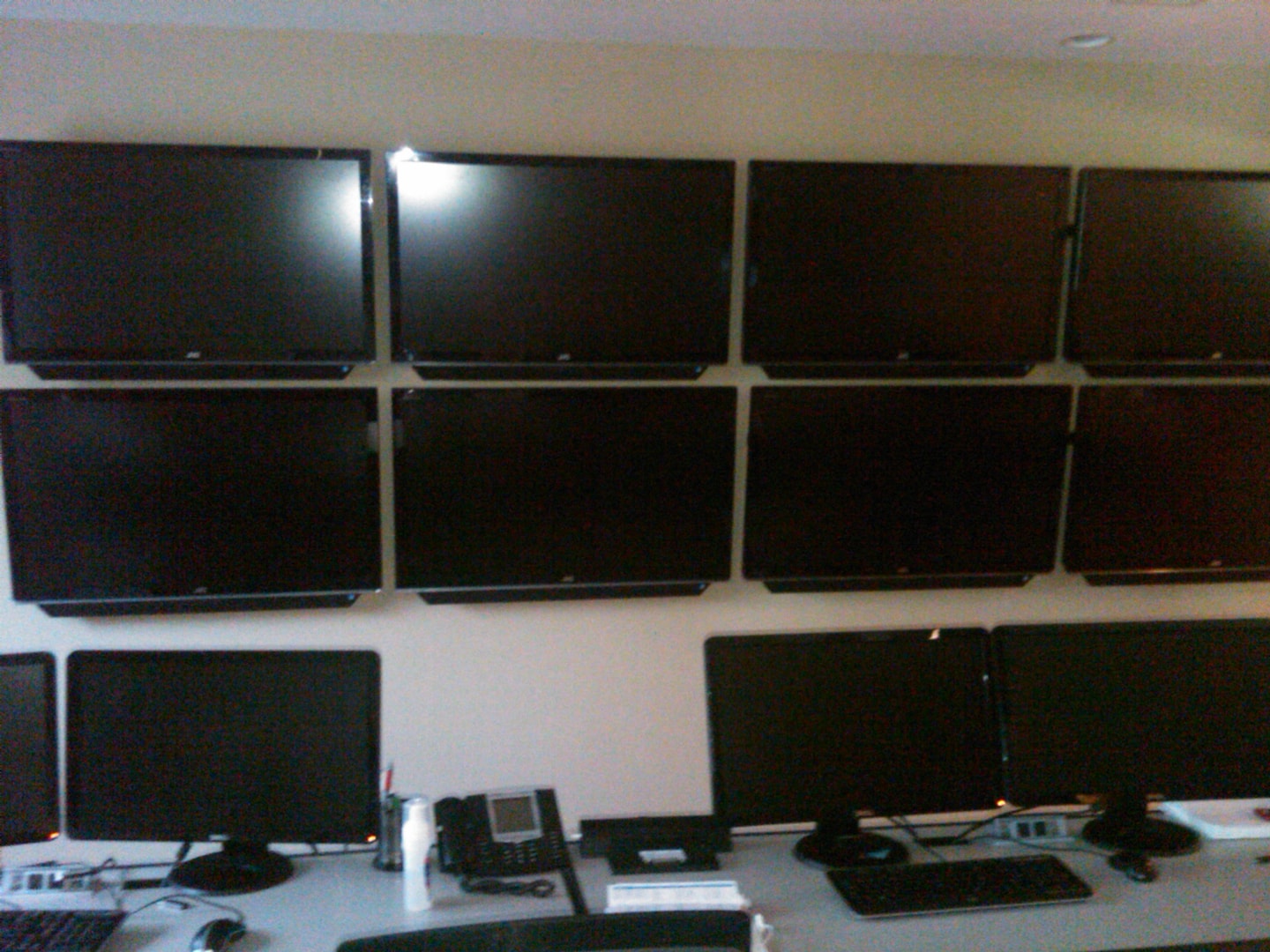 Commercial control room with multiple wall-mounted monitors in grid formation