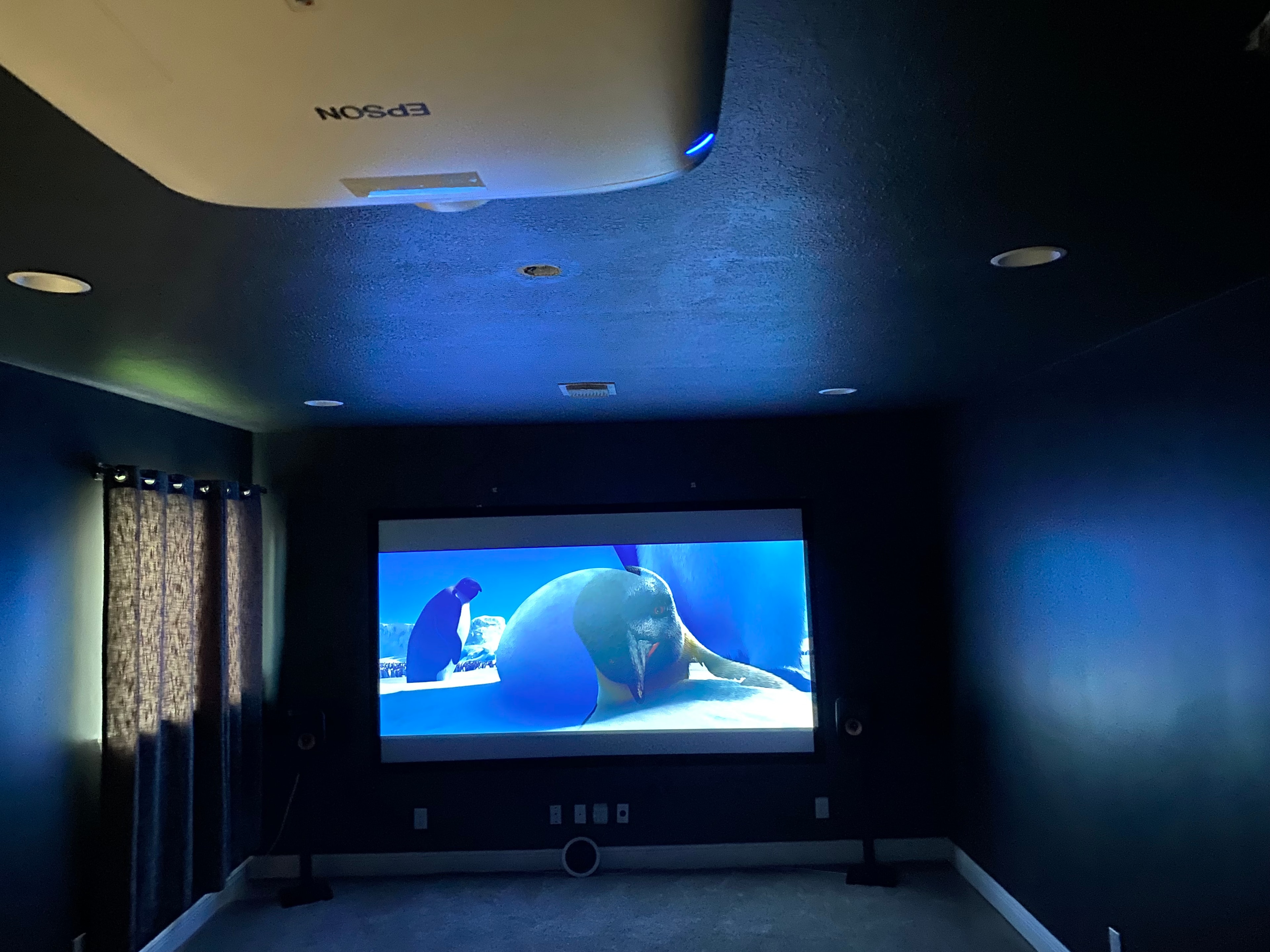 Home theater room with projection screen and seating