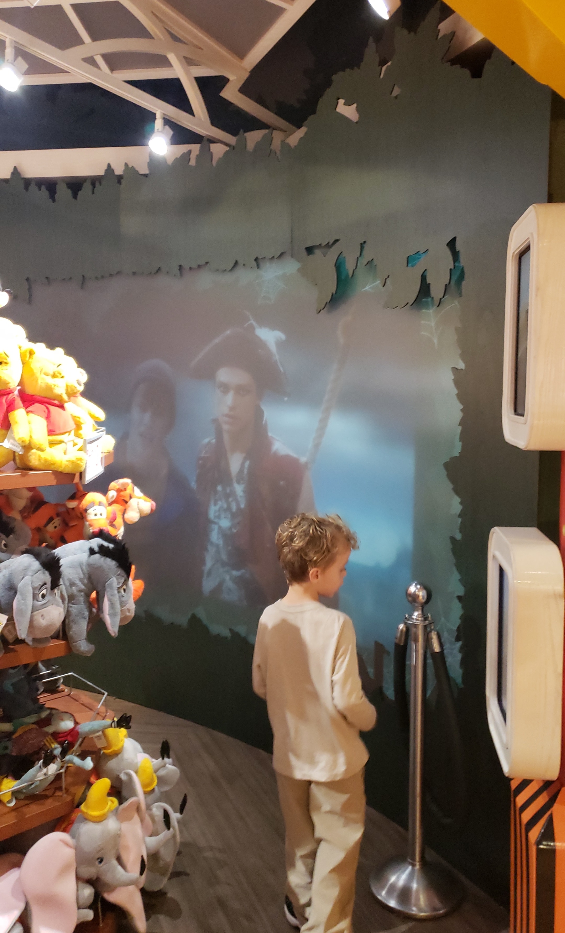 Child watching interactive castle projection display — ceiling-mounted projector