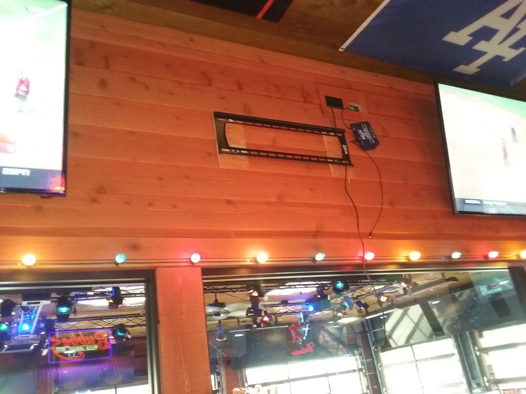 Arcade interior with orange wood wall — entertainment venue AV